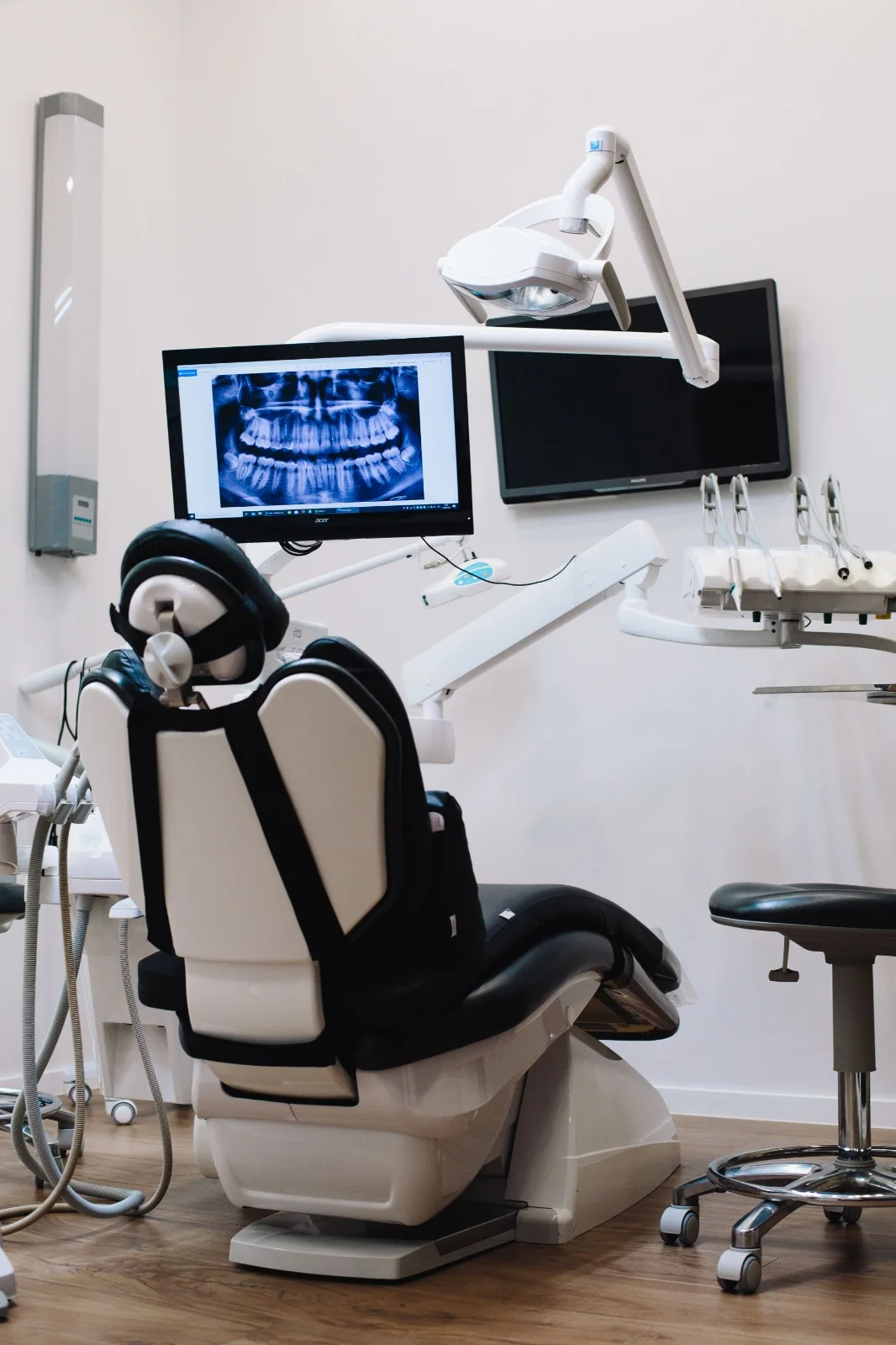 Modern dental surgery with treatment chair, x-ray monitor and clinical equipment